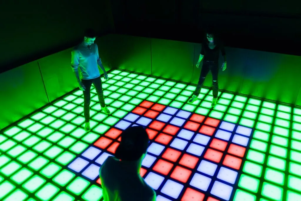 Guests playing Pixel interactive floor game at Bury the Hatchet