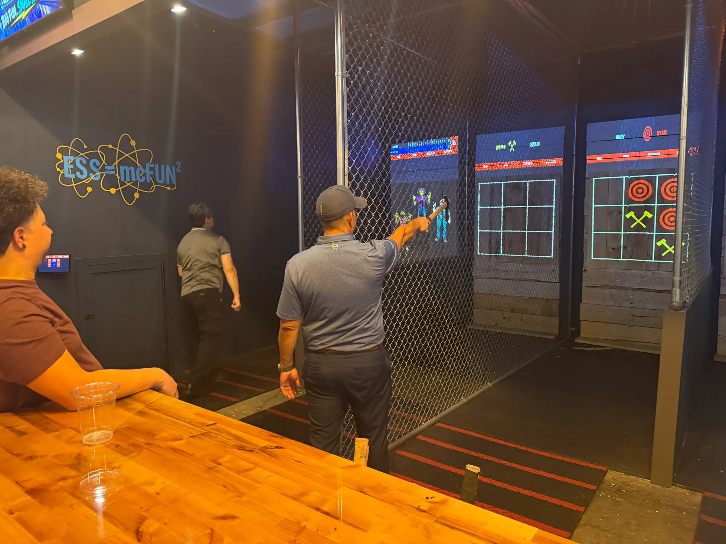 Guests throwing axes at projected targets at Electric Sports Social