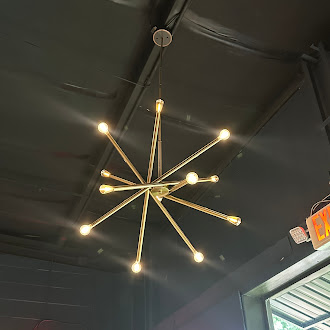 Brass sputnik chandelier over the dining room at Electric Sports Social